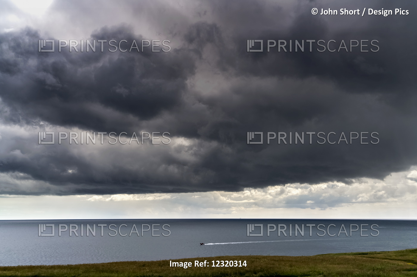 Ominous Dark Clouds Over The Ocean And A Small Boat Traveling Along The ...