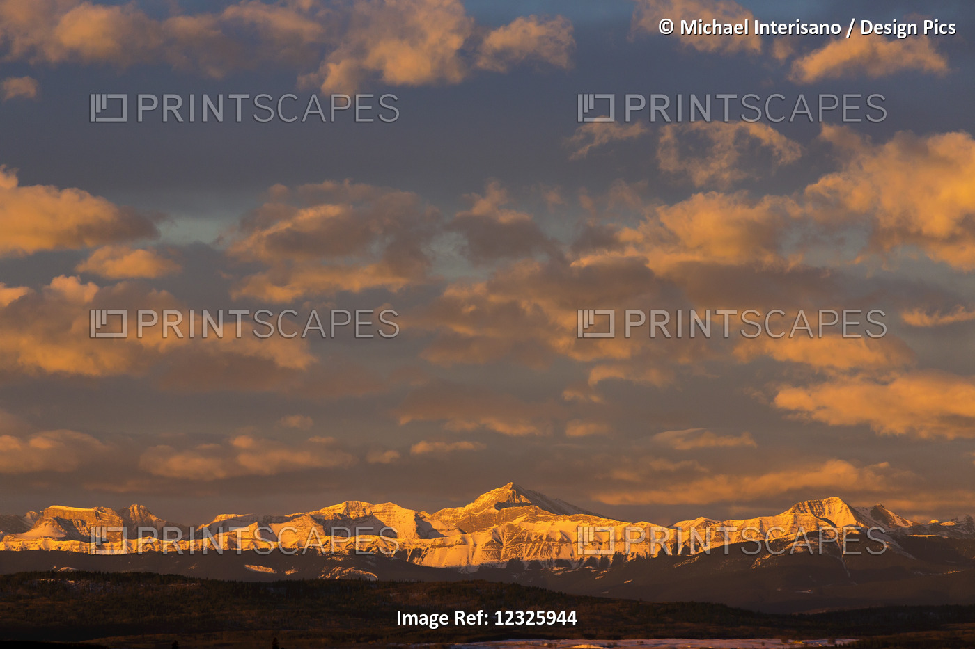 Glowing Warmly Lit Snow Covered Mountain Range And Foothills With Glowing ...